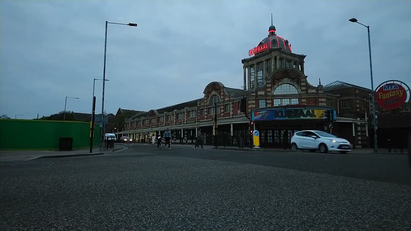 The Kursaal on Southchurch Avenue in Southend at dusk, traffic passing