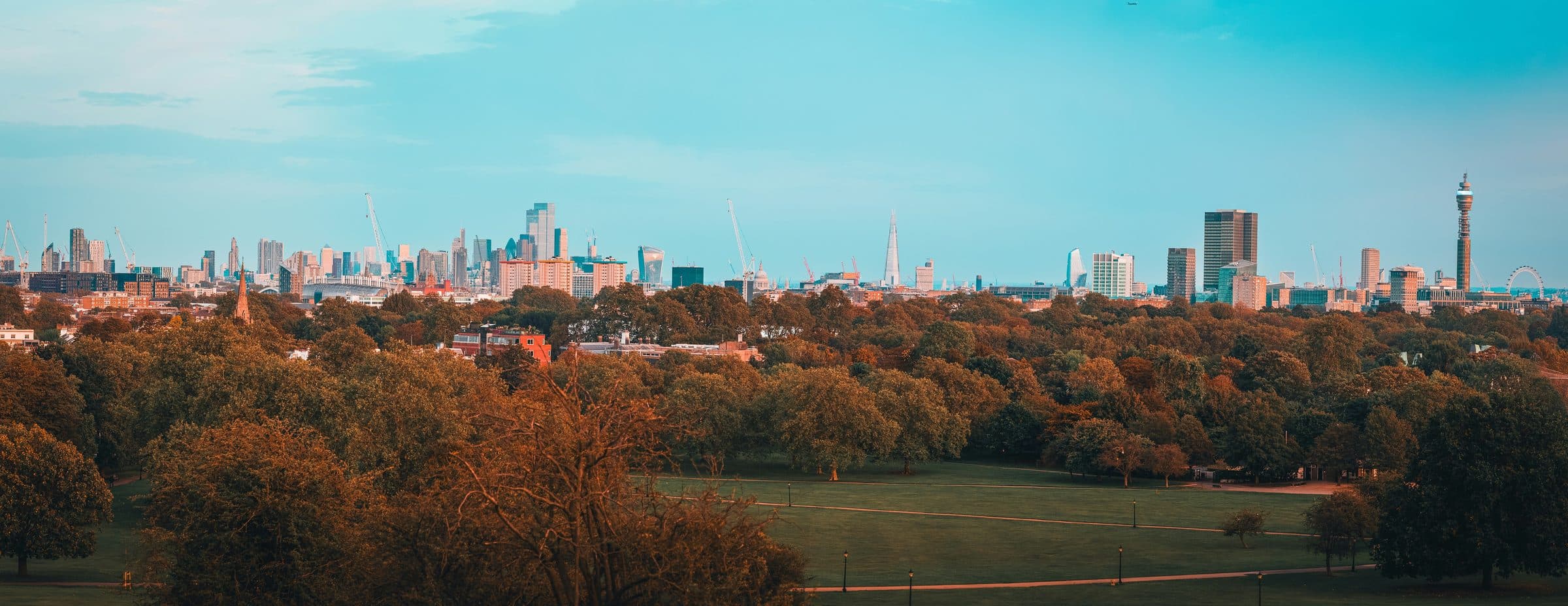 An autumn view over London from the top of Primrose Hill, with the towers of the City on the skyline
