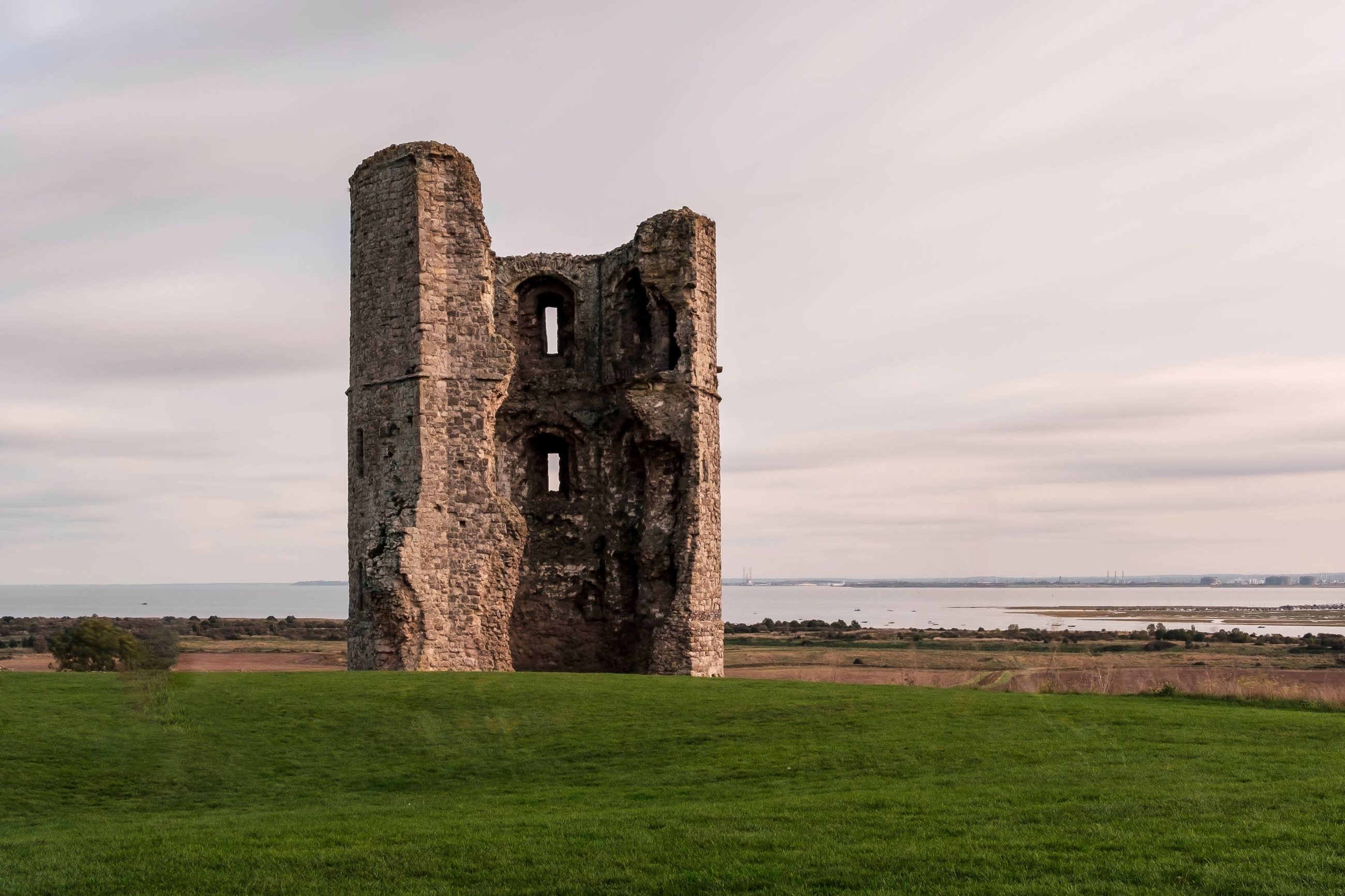 The ruined tower of Hadleigh Castle in Essex on its grass hill above the Thames estuary