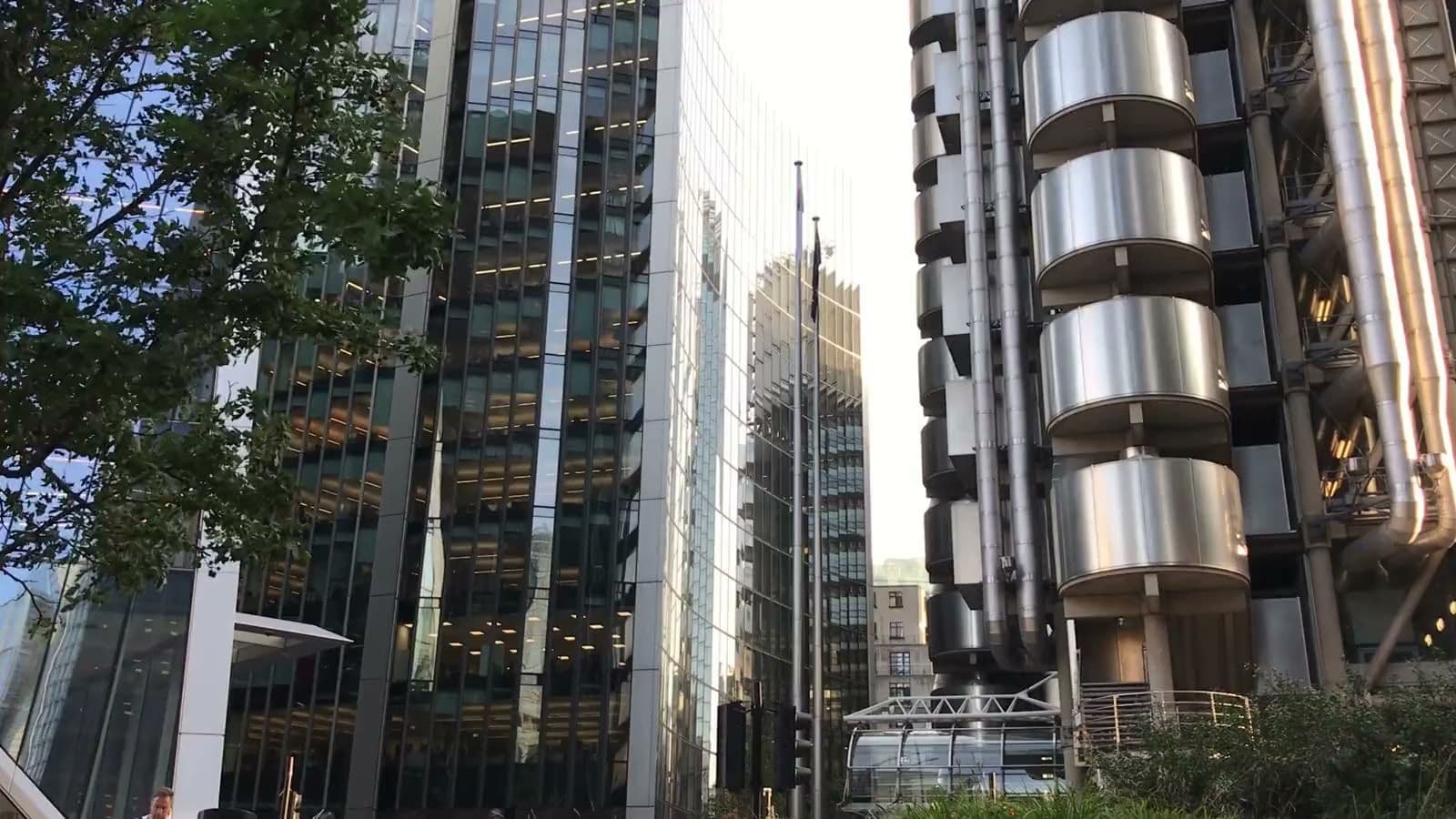 The steel service towers of the Lloyd's building on Lime Street in the City of London, a tree in front