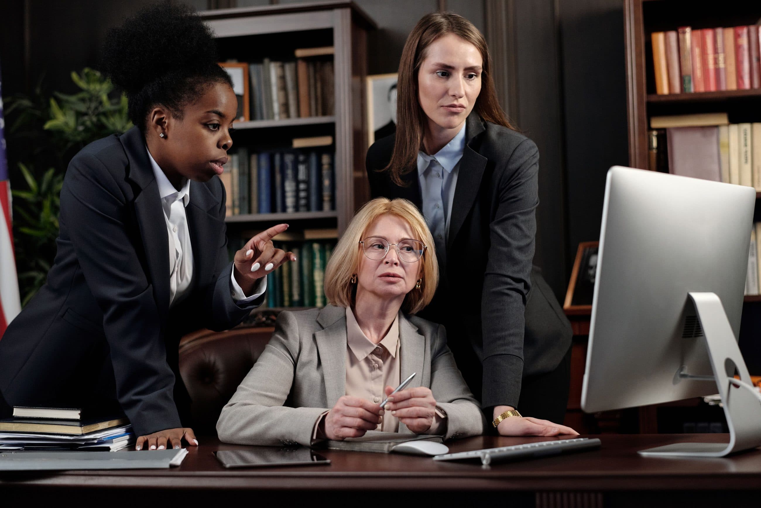 Three lawyers reviewing a case together at a desk