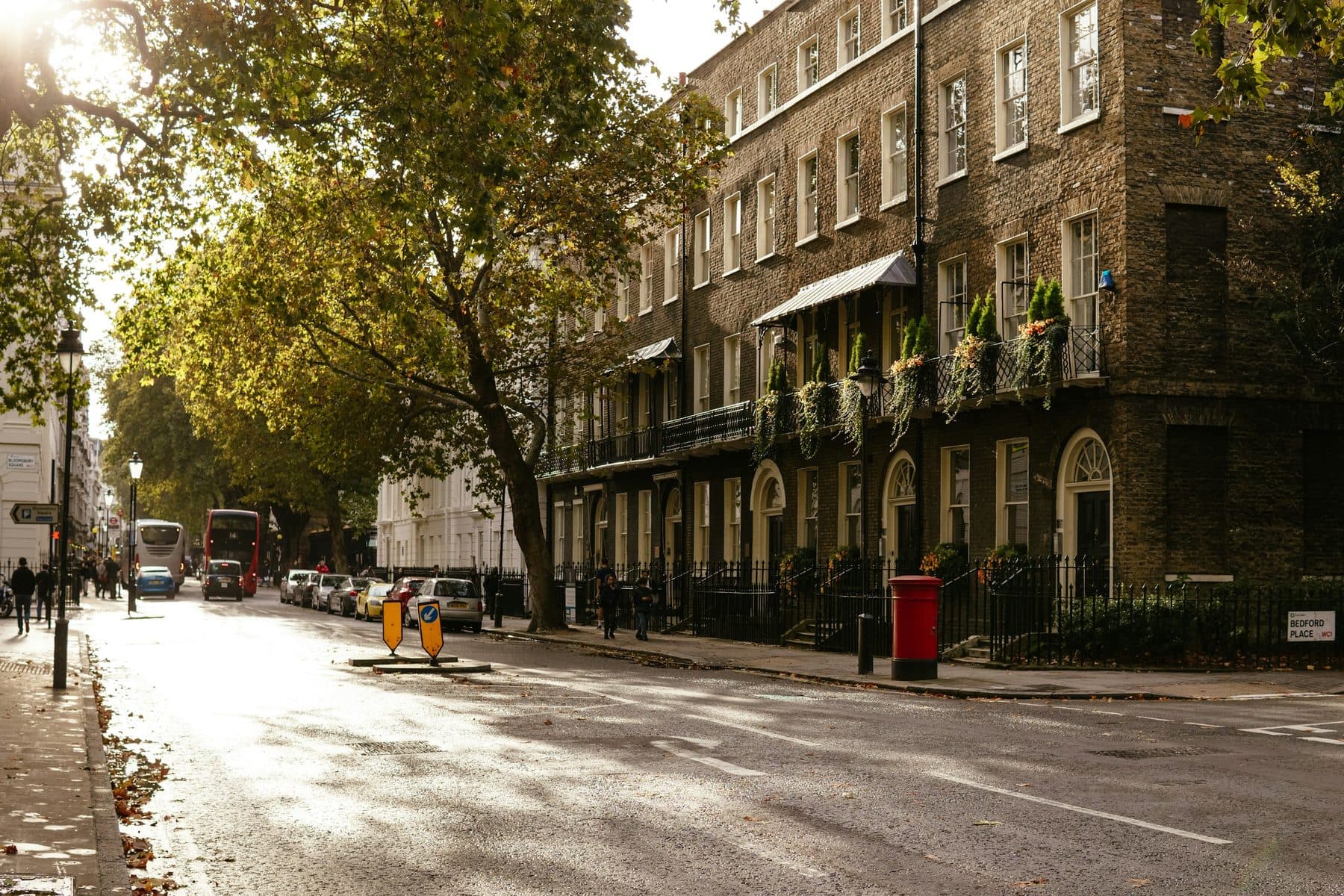 A Georgian brick terrace on a tree lined street in Bloomsbury, London, in low autumn sun