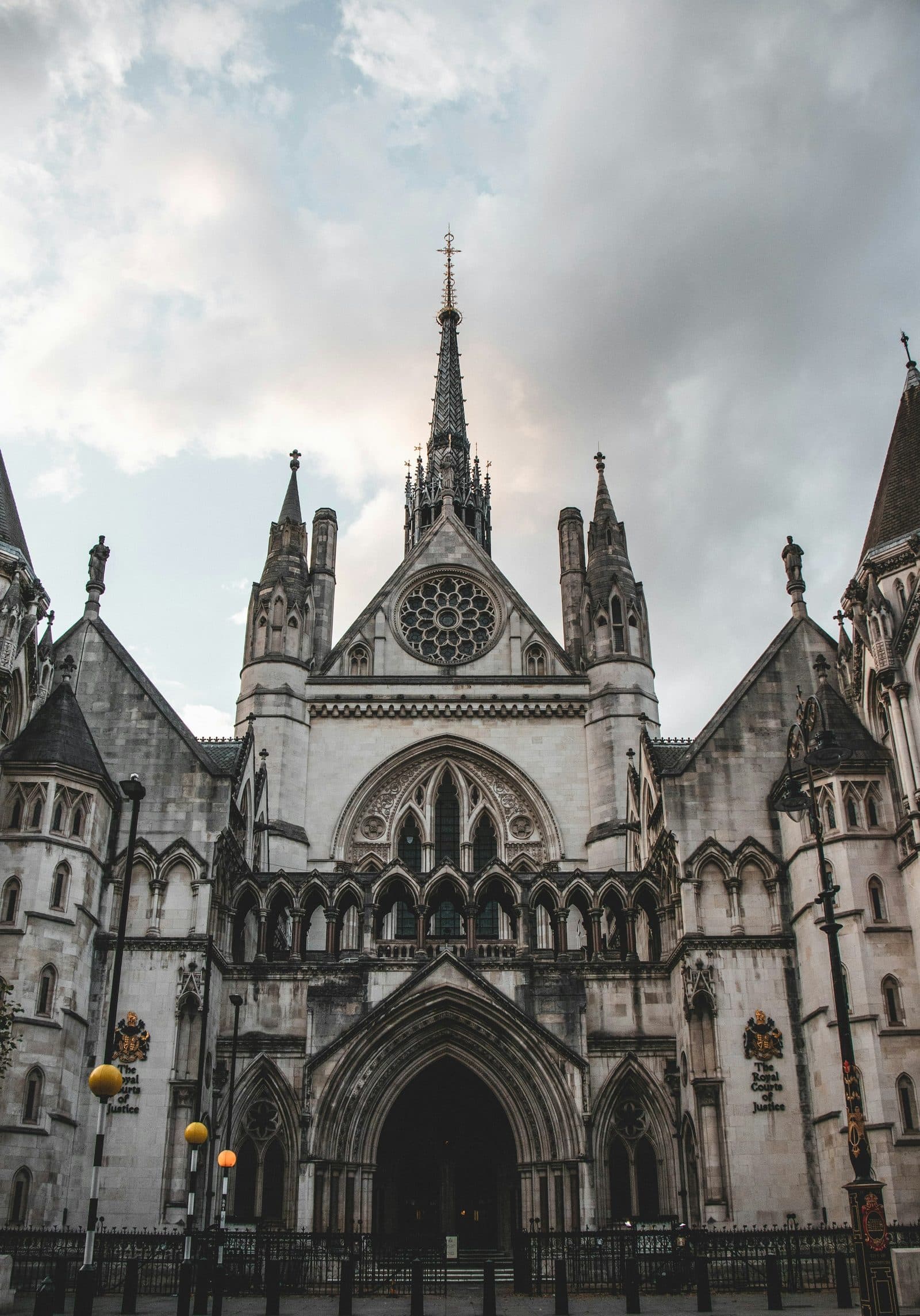 The main entrance and spire of the Royal Courts of Justice on the Strand, seen from the pavement