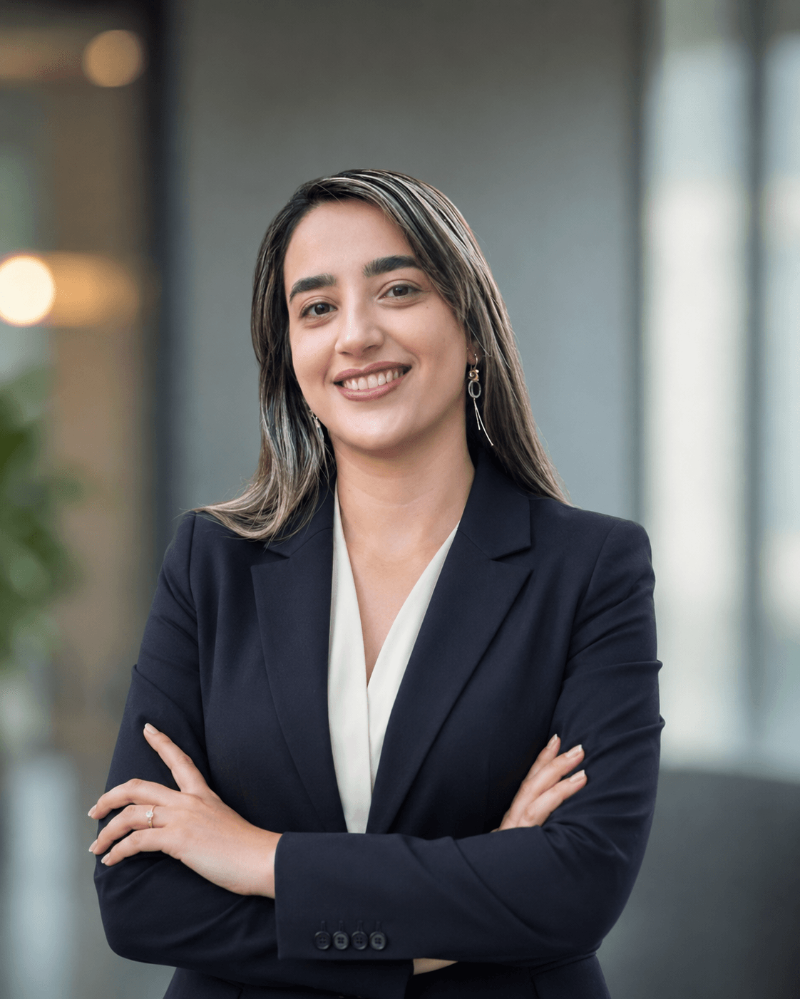 Neda Yavari, founder of Proxima, smiling with her arms folded