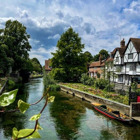The Great Stour in Canterbury, lined with flower beds and timber-framed houses